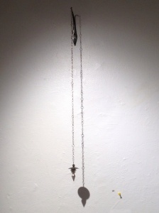 Ana M. Lopez: "Plumb Bob: Shelter" (installation view). Sterling silver, 14K yellow gold, forged steel, 2.75" x 1.75" x 29.5", 2012.