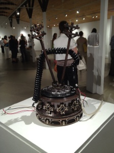Becky McDonah, "Lost Connection: A Reliquary for the Telephone Cord" (installation view). Copper, sterling, fine silver, pearls, onyx, enamel, found telephone parts, 11" x 6" x 6", 2012.